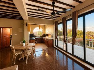 a kitchen and dining room with a table and chairs at Raffia Boutique Hotel in Jambiani