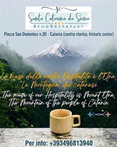 a coffee mug sitting on a table with a mountain at Santa Caterina da Siena B&B in Catania