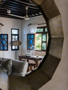 a living room with a couch and a table at Lamu Treasures Shela Kenya in Shela
