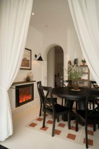 a dining room with a table and a fireplace at Hanachi Stay in Ho Chi Minh City