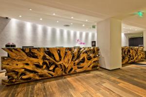 a lobby with a large wall of tree branches at Meliá Paulista in São Paulo