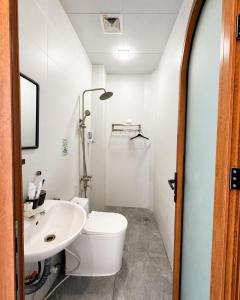 a bathroom with a white toilet and a sink at Coco Bay Hon Son in Lai Sơn +190 photos
