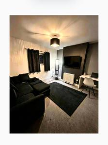 a living room with a couch and a table at 13a Avon road in Worcester