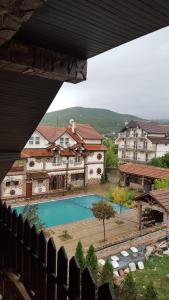 a view of a swimming pool in front of some buildings at Apartments Dan Dar in Nov Dojran