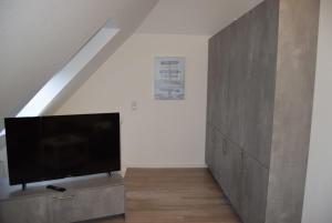 a living room with a flat screen tv on a cabinet at App "Ahoi" Familie Köhn in Schönberger Strand