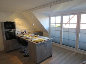 a kitchen with a island with a counter top at App "Ahoi" Familie Köhn in Schönberger Strand