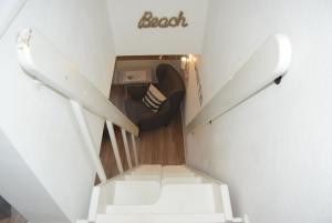 a stairway with a couch and a chair at App "Ahoi" Familie Köhn in Schönberger Strand