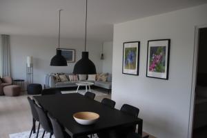 a living room with a black table and chairs at Holiday Home On Bornholm Close To Sea And Beach in Vester Sømarken
