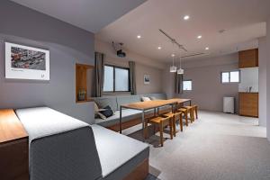 a living room with a table and a dining room at 9STAY Kikukawa in Tokyo