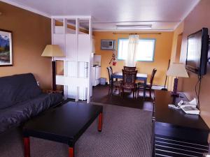 a living room with a couch and a table at Alpine Inn & Suites in Revelstoke