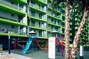 a playground in front of a apartment building at Apartament Alezzi Beach in Năvodari