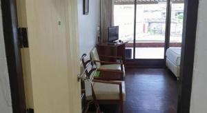 a room with a bed and a chair and a television at SA hotel in Trat +102 photos