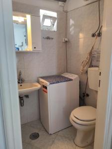 a small bathroom with a toilet and a sink at Michalis little sunrise in Mamádhos