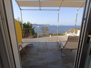 a balcony with a table and chairs and the ocean at AzzurroMare Ponza Rooms Sea View by Caseaponza it in Ponza +32 photos