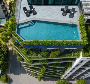 an overhead view of a swimming pool in a building at Taiyo Hotel & Apartment in Danang