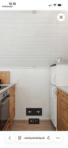 a kitchen with a stove and a white refrigerator at Modern Oasis Surrounded By Nature in Ry