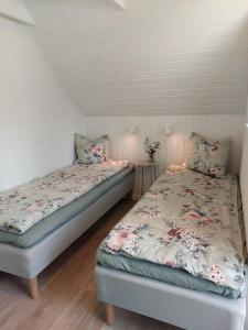 two twin beds in a room with at Modern Oasis Surrounded By Nature in Ry