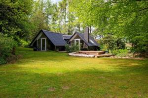 a small house in the middle of a yard at Modern Oasis Surrounded By Nature in Ry