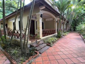 a house with a brick walkway in front of it at Kep Ocean Inn in Kep