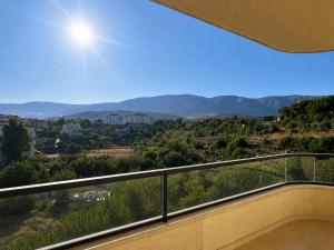 a view of the mountains from the balcony of a house at Countryside Guesthouse in Kafr Nabrakh