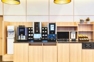 a counter with several microwaves on top of it at Karaksa Hotel Osaka Namba in Osaka