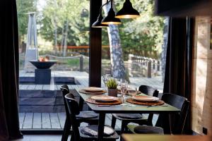 a table with plates and wine glasses on a patio at Glamping Babákov in Včelákov