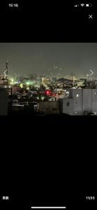 a view of a city at night with lights at Lumi living hostel in Ho Chi Minh City