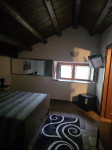 a bedroom with a bed and a television in it at La Dimora del Grifo in Mascalucia