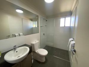 a bathroom with a white toilet and a sink at Dooley's Tavern & Motel Springsure in Springsure +42 photos