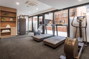 a gym with treadmills and ellipticals in a building at Brady Hotels Elizabeth Street in Melbourne