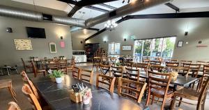 a dining room with tables and chairs in a room at Dooley's Tavern & Motel Springsure in Springsure