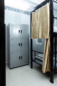 a room with two lockers and a mirror at Lumi living hostel in Ho Chi Minh City