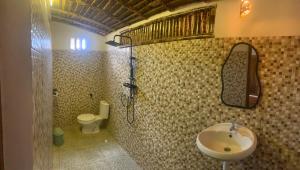 a bathroom with a sink and a toilet at Balee kayuu in Gili Gede