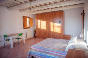 a bedroom with a bed and a table in it at Alloggi degli Artisti in Case Selva Grande +17 photos