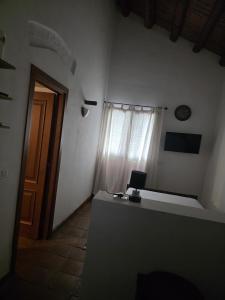 a room with a desk and a window and a door at La Dimora del Grifo in Mascalucia +6 photos