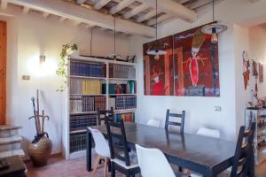 a dining room with a wooden table and chairs at Alloggi degli Artisti in Case Selva Grande