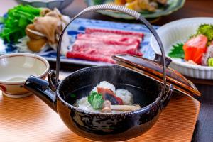 a pot of food sitting on top of a table at Okamotoya in Beppu +94 photos
