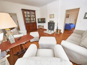 a living room with white furniture and a fireplace at Gutshaus Glowitz in Glowitz