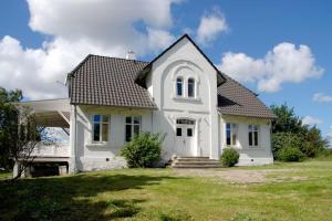 a white house with a black roof at Gutshaus Glowitz in Glowitz +77 photos