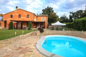 a large swimming pool in front of a house at Alloggi degli Artisti in Case Selva Grande