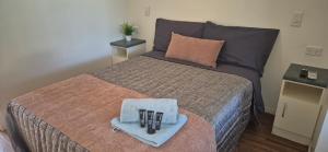 a bedroom with a bed with a tray with pens on it at Gday Parks Emerald in Emerald +1 photo