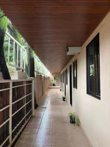 an empty hallway of a building with a wooden ceiling at WKND Casa in Panchgani