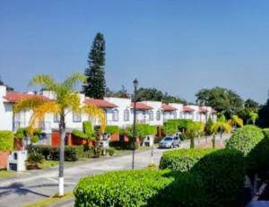 a street with a row of houses and trees at VILLA REAL lll YAUTEPEC in Yautepec de Zaragoza