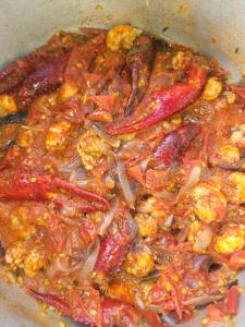 a bowl of food with meat and other ingredients at Ruhondo Campsite View in Muhororo