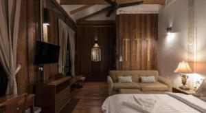 a bedroom with a bed and a couch and a tv at Uthai Heritage Hotel in Ban Nong Nam Khan +253 photos