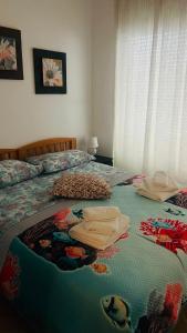 a bedroom with a large bed with a colorful blanket at Phoenix in Peroj