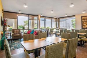 a restaurant with tables and chairs and windows at Quality Inn West Fort Worth in Fort Worth