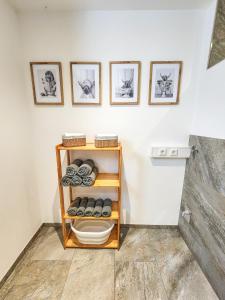 a shelf in a room with photos on the wall at Ferienwohnung auf dem Stroblhof in Polling