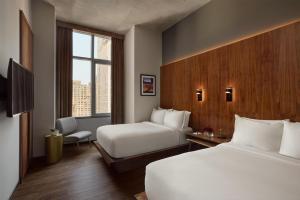a hotel room with two beds and a window at Grayson Hotel in New York