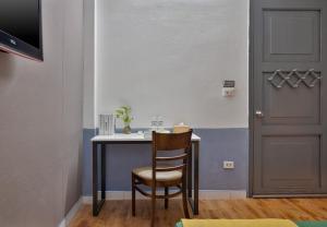 a room with a table and a chair and a door at Hanoi Sihouse Eco in Hanoi